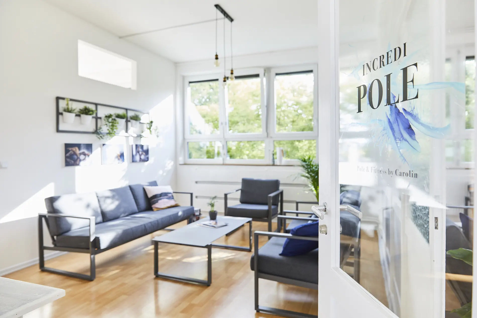 Loungebereich hinter einer Glaswand mit IncrediPOLE-Logo
